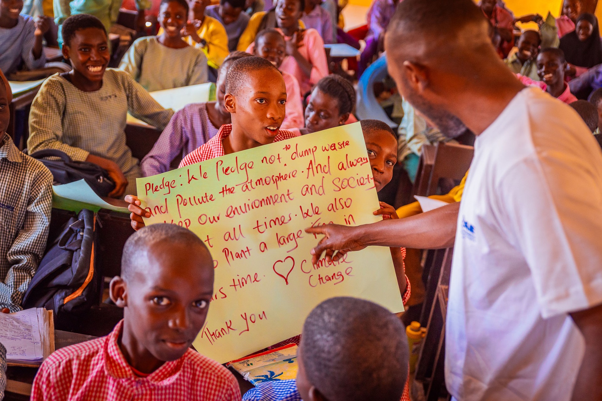 Students sharing a climate pledge during a CCAIE classroom activity